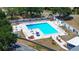 Aerial view of the community pool with plenty of seating and lush landscaping at 3728 Parkway Blvd, Land O Lakes, FL 34639