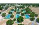 Overhead view of a large group of lovely blue and green tennis courts surrounded by lush trees and well maintained grounds at 3728 Parkway Blvd, Land O Lakes, FL 34639