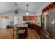 Well-lit kitchen featuring granite countertops, stainless steel appliances, dark wood cabinets and a kitchen island with seating at 3738 Coppertree Cir, Brandon, FL 33511