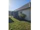 Exterior home view includes tile roof, lush landscaping, window, and screened porch at 4043 La Pasida Ln, New Port Richey, FL 34655