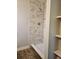 A shower featuring marble-like tile, a shower head and tiled base at 4043 La Pasida Ln, New Port Richey, FL 34655