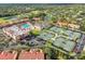Aerial view of community featuring a pool, tennis courts, landscaped grounds, and residential buildings at 4175 Northmeadow Cir # 4175, Tampa, FL 33618