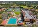 Aerial view of community featuring a pool, tennis courts, landscaped grounds, and residential buildings at 4175 Northmeadow Cir # 4175, Tampa, FL 33618