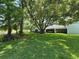 Backyard featuring lush greenery with view of the home and screened in lanai at 4175 Northmeadow Cir # 4175, Tampa, FL 33618