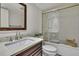 Bright bathroom featuring a vanity with granite countertop, and a shower over tub with glass sliding doors at 4175 Northmeadow Cir # 4175, Tampa, FL 33618