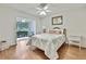 Cozy bedroom featuring a ceiling fan, sliding glass doors leading to outdoor space, and wood flooring at 4175 Northmeadow Cir # 4175, Tampa, FL 33618