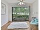 Bedroom featuring a white rug, comfortable seating and views of the natural landscape through sliding glass doors at 4175 Northmeadow Cir # 4175, Tampa, FL 33618