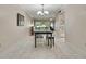 Inviting dining area with a table setting, view to the living room, and access to the kitchen at 4175 Northmeadow Cir # 4175, Tampa, FL 33618