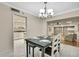Dining room features a modern chandelier, table setting for four, and easy access to the kitchen at 4175 Northmeadow Cir # 4175, Tampa, FL 33618