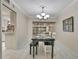 This dining area boasts an elegant chandelier, ample seating, and easy access to the kitchen at 4175 Northmeadow Cir # 4175, Tampa, FL 33618
