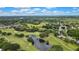 Expansive aerial view of a scenic golf course with a pond and scattered mature trees at 4175 Northmeadow Cir # 4175, Tampa, FL 33618