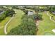 Scenic aerial view of a lush green golf course with mature trees and a tranquil pond at 4175 Northmeadow Cir # 4175, Tampa, FL 33618