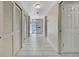 Bright hallway with white tile floors, closet doors, and an inviting view of the front door at 4175 Northmeadow Cir # 4175, Tampa, FL 33618