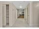 Well-lit hallway with tile flooring, closet space, and a glimpse into the living room at 4175 Northmeadow Cir # 4175, Tampa, FL 33618