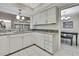 This kitchen features white cabinets, stainless steel appliances, granite countertops and easy access to the dining room at 4175 Northmeadow Cir # 4175, Tampa, FL 33618