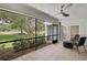 Screened-in lanai offering beautiful green views, a ceiling fan, and an outdoor seating area at 4175 Northmeadow Cir # 4175, Tampa, FL 33618