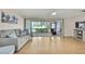 Bright living room features a ceiling fan, hardwood flooring, and sliding glass doors to the lanai at 4175 Northmeadow Cir # 4175, Tampa, FL 33618