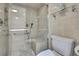 Accessible tile shower with glass door, built-in shelving, grab bars and a comfortable seating area at 4175 Northmeadow Cir # 4175, Tampa, FL 33618