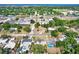 Wide aerial view of a neighborhood with houses, trees, streets, and a glimpse of the ocean in the background at 4310 S Coolidge Ave, Tampa, FL 33611