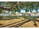 Large backyard with shade tree, privacy fence, and covered patio at 4310 S Coolidge Ave, Tampa, FL 33611