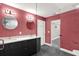 Modern bathroom features a double sink vanity, stylish lighting fixtures, and glass enclosed shower at 4310 S Coolidge Ave, Tampa, FL 33611