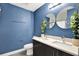 Bathroom features a double sink vanity, stylish mirrors, and decorative plants at 4310 S Coolidge Ave, Tampa, FL 33611