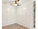 Bedroom features wall of storage, ceiling fan, and light wood-look floors at 4310 S Coolidge Ave, Tampa, FL 33611