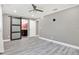 Spacious bedroom with ensuite bathroom featuring an open sliding door and modern wood-look flooring at 4310 S Coolidge Ave, Tampa, FL 33611
