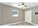 Neutral bedroom with ceiling fan, closet, window and light wood-look floors at 4310 S Coolidge Ave, Tampa, FL 33611