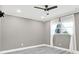 Empty bedroom with a ceiling fan, wood-look flooring, fresh paint and bright natural light at 4310 S Coolidge Ave, Tampa, FL 33611