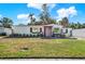 Charming single-story home featuring fresh exterior paint, manicured landscaping, and a vibrant pink front door at 4310 S Coolidge Ave, Tampa, FL 33611