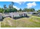 Well-maintained single-story home featuring a landscaped yard, fresh exterior paint and a charming pink front door at 4310 S Coolidge Ave, Tampa, FL 33611