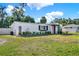 Charming single-story house with a well-kept lawn, landscaped garden beds, and fresh exterior paint at 4310 S Coolidge Ave, Tampa, FL 33611