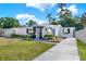 Inviting single-story home with landscaped garden beds, fresh exterior paint, and a well-manicured lawn at 4310 S Coolidge Ave, Tampa, FL 33611