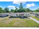Beautifully landscaped single-story home with a well-maintained lawn, pink front door, and fresh exterior paint at 4310 S Coolidge Ave, Tampa, FL 33611
