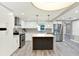 Well-lit kitchen with stainless steel appliances, ample cabinet space, and center island with pendant lights at 4310 S Coolidge Ave, Tampa, FL 33611