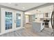 Modern kitchen with stainless steel appliances, white cabinetry, a spacious island, and stylish pendant lighting at 4310 S Coolidge Ave, Tampa, FL 33611
