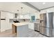 Bright kitchen with white cabinets, stainless steel appliances, and a gray quartz island at 4310 S Coolidge Ave, Tampa, FL 33611