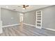Stylish living room featuring gray walls, laminate floors, and a modern white shelving unit at 4310 S Coolidge Ave, Tampa, FL 33611