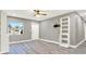 Modern living room showcasing gray walls, stylish laminate floors, and a sleek white shelving unit at 4310 S Coolidge Ave, Tampa, FL 33611