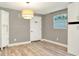 Neutral room with a statement light fixture, white trim, and durable wood-look flooring at 4310 S Coolidge Ave, Tampa, FL 33611