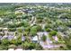 An aerial view of a neighborhood with tree-lined streets, manicured lawns, and charming homes at 511 San Jose Dr, Dunedin, FL 34698