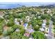 Picturesque aerial shot of homes nestled among green trees in a quiet residential area near the water at 511 San Jose Dr, Dunedin, FL 34698