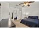 Bedroom featuring a ceiling fan, closet, and ensuite with coordinated bedding and furniture at 511 San Jose Dr, Dunedin, FL 34698