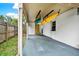 Covered carport featuring stored kayaks, concrete floor, and a view of the backyard at 511 San Jose Dr, Dunedin, FL 34698