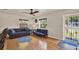 Comfortable living room with hardwood floors, natural light, a ceiling fan and stylish decor at 511 San Jose Dr, Dunedin, FL 34698