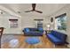Bright living room featuring hardwood floors, a ceiling fan, and ample natural light at 511 San Jose Dr, Dunedin, FL 34698