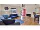 Well-lit living room with hardwood floors, stylish furniture, and a red front door at 511 San Jose Dr, Dunedin, FL 34698