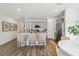 Open-concept kitchen featuring gray cabinetry, stainless steel appliances, an island, and wood flooring at 5133 Harbinger Rd, Spring Hill, FL 34608