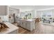 Open living space with hardwood flooring, an island with a sink, and natural light at 5133 Harbinger Rd, Spring Hill, FL 34608